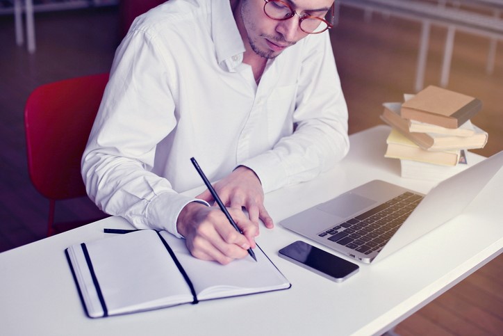 Man writing in book